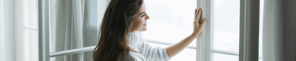lady standing close to the window closing it