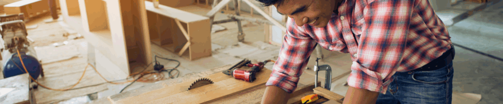 a construction worker working at a table with blueprints for a house