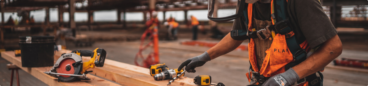 A man drilling wood on a workbench.