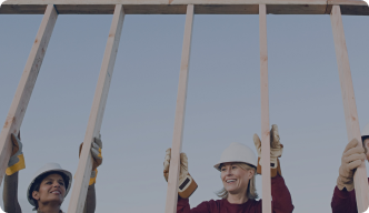 A group of construction workers putting up a frame.