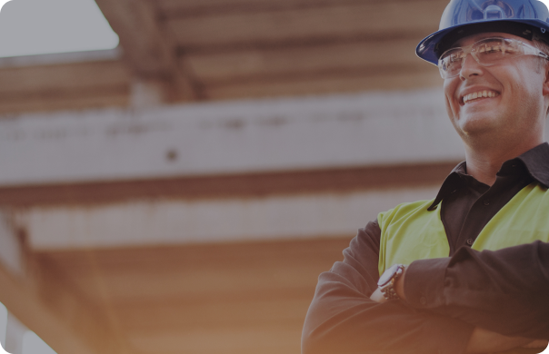 A man in a hard hat smiling.